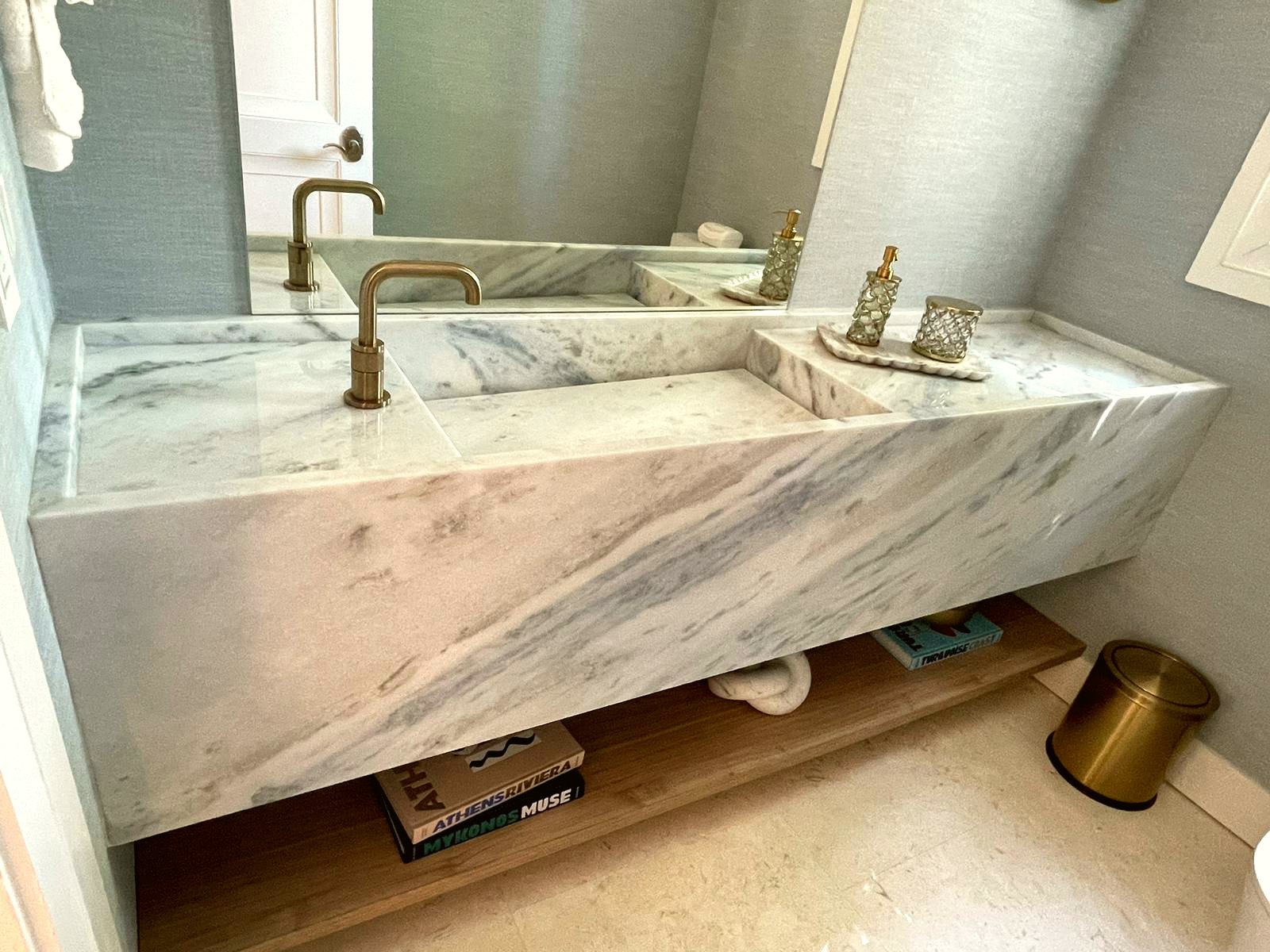 Floating marble vanity with gold faucet — real project