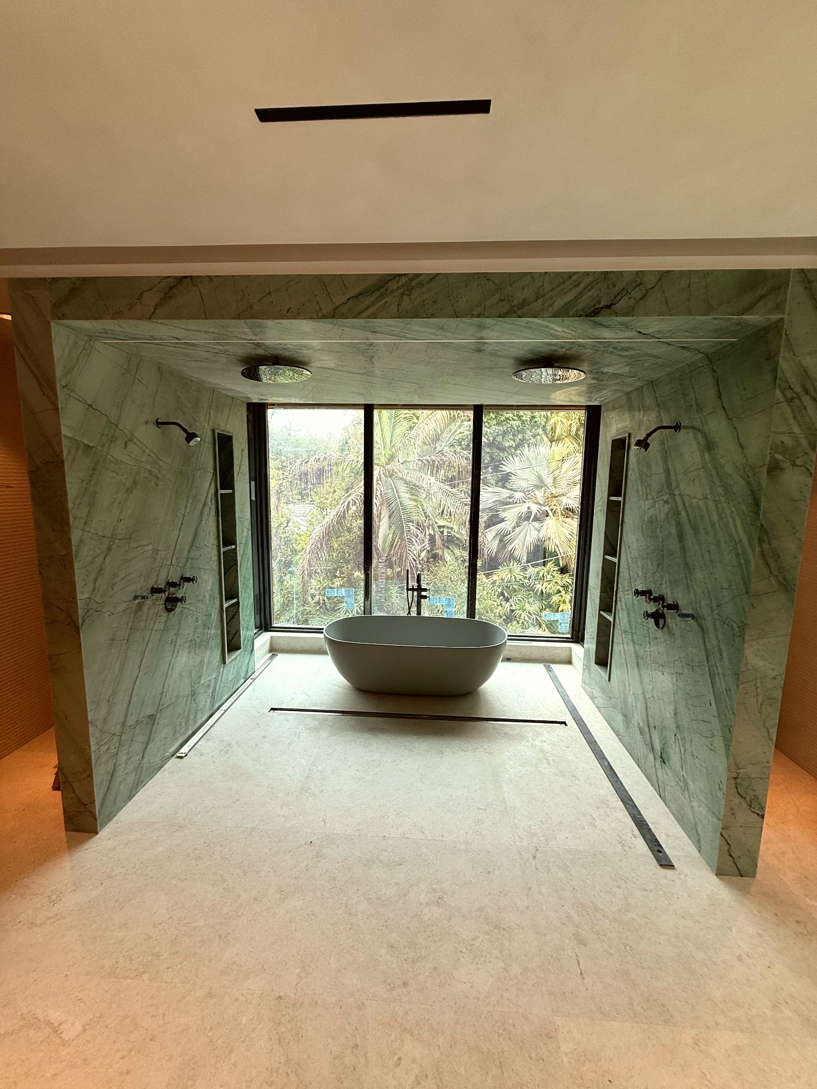 Marble spa bathroom with freestanding tub — real Miami project