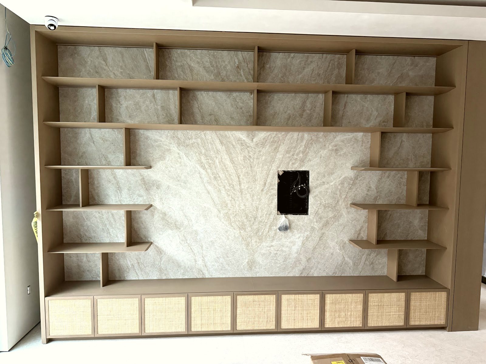 Stone shelving feature wall — real Miami project