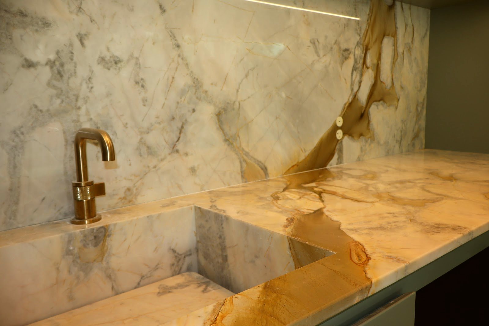 Gold-veined marble integrated sink — real Miami project