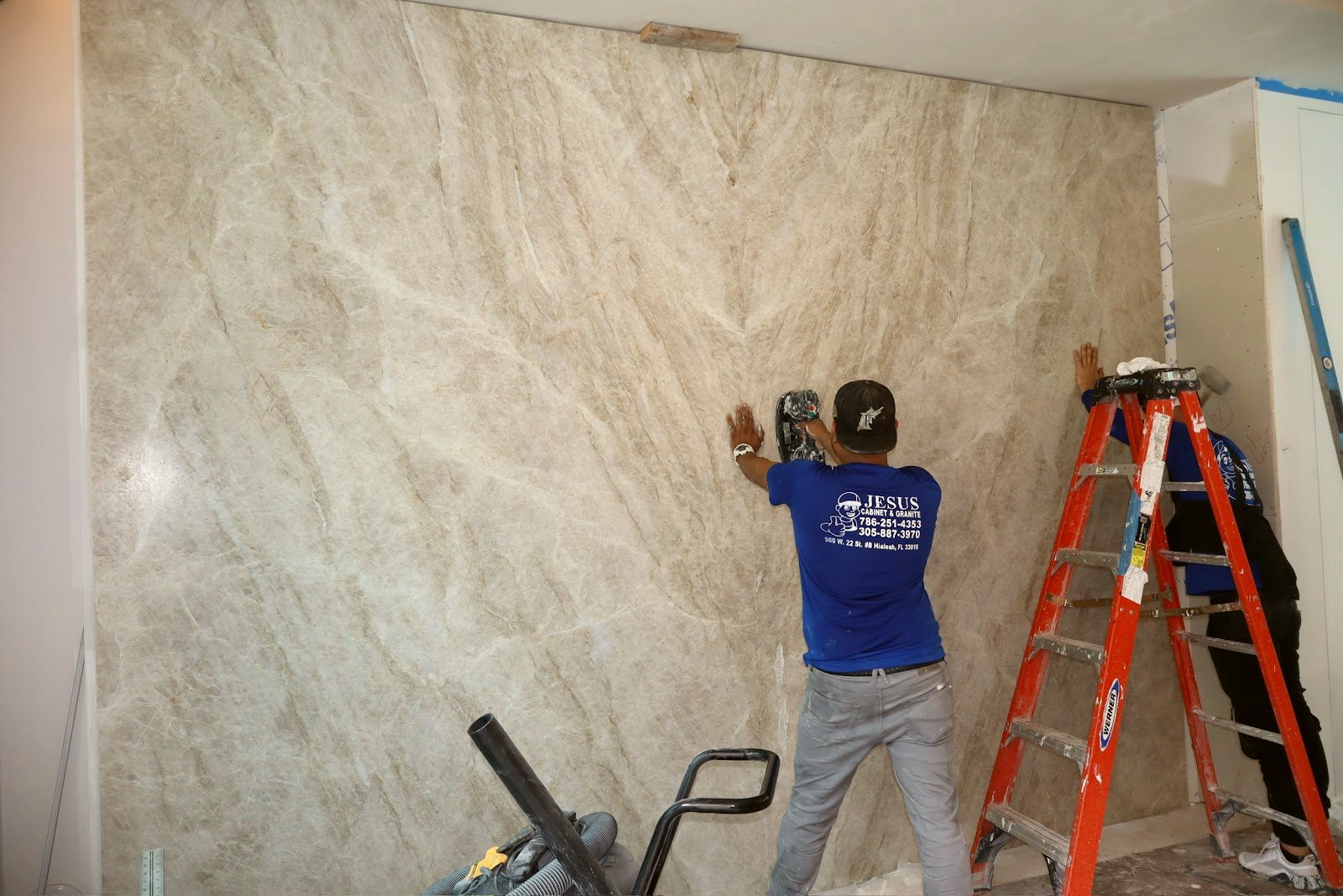 Our crew installing large-format stone wall panels